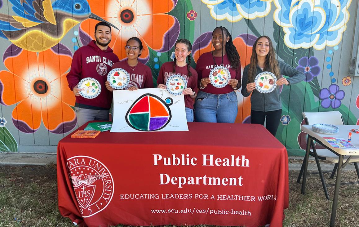 Students from the public health department pose at local health fair. Group of students from SCU's Public Health Department pose at event.